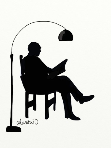 silueta de hombre leyendo junto a una lámpara
